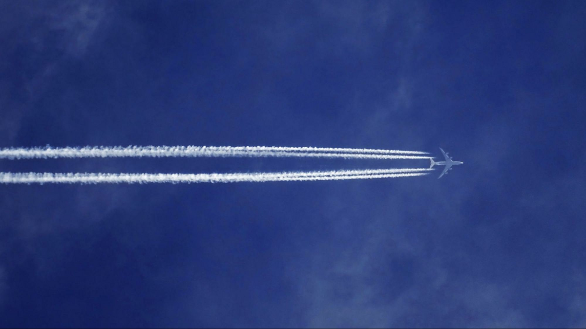 an airplane with exhaust trails in a blue sky, as shown in the Davis Estate wine blog post featuring a Napa valley airports guide and flights to Napa