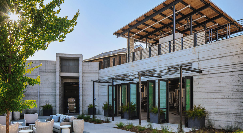 A modern building with outdoor seating and a rooftop patio | Best Wineries in Calistoga