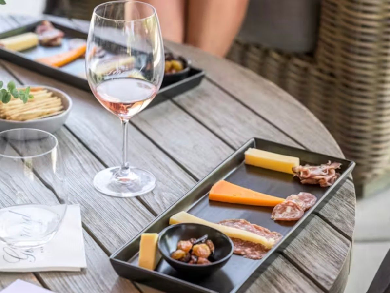 A nearly empty glass of wine sits on a table surrounded by tasting plates | Best Wineries in Calistoga