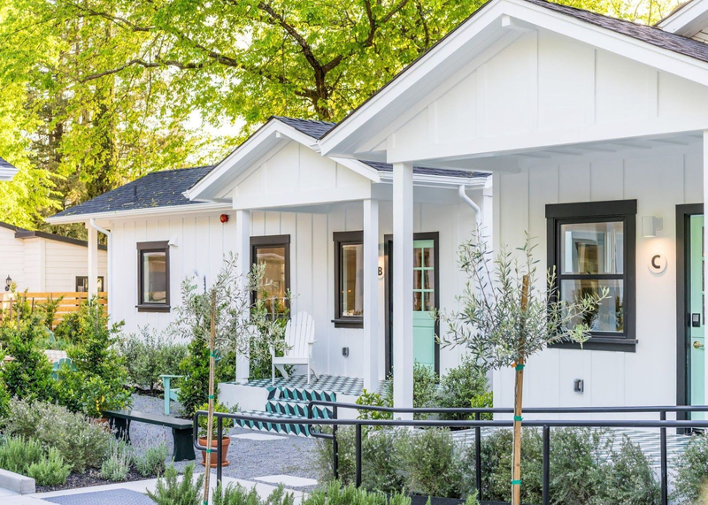 An adorable white bungalow with teal doors | Best Calistoga Hotels