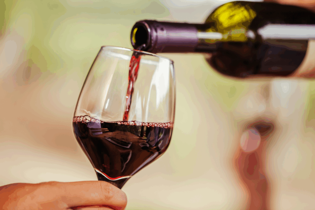Red wine being poured into a glass at Napa winery