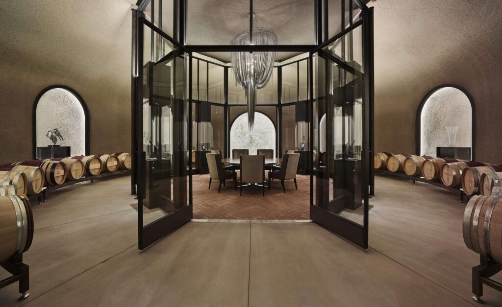 Luxury wine cellar with barrels and glass dining room