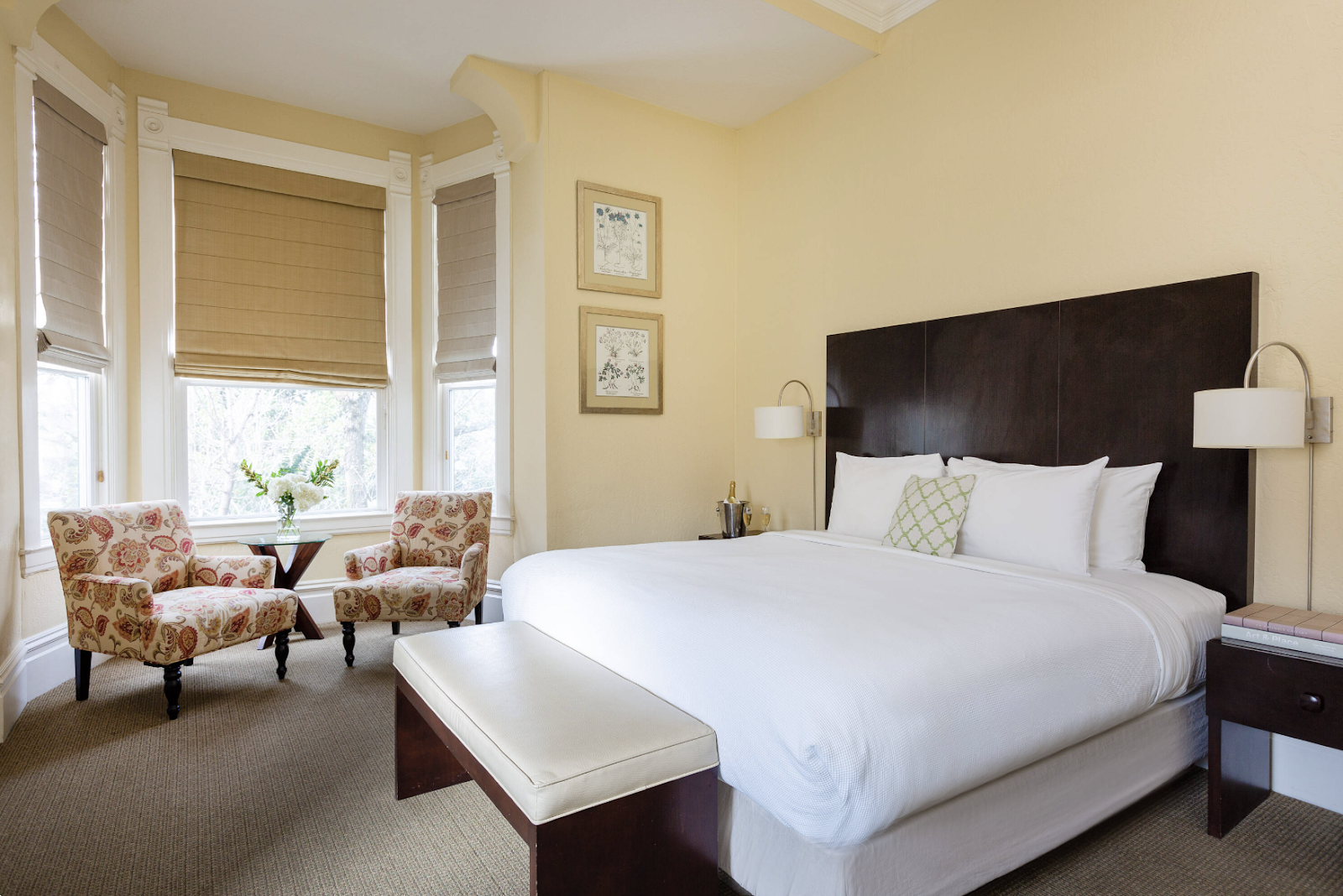 Bright bedroom with king bed and bay window seating area