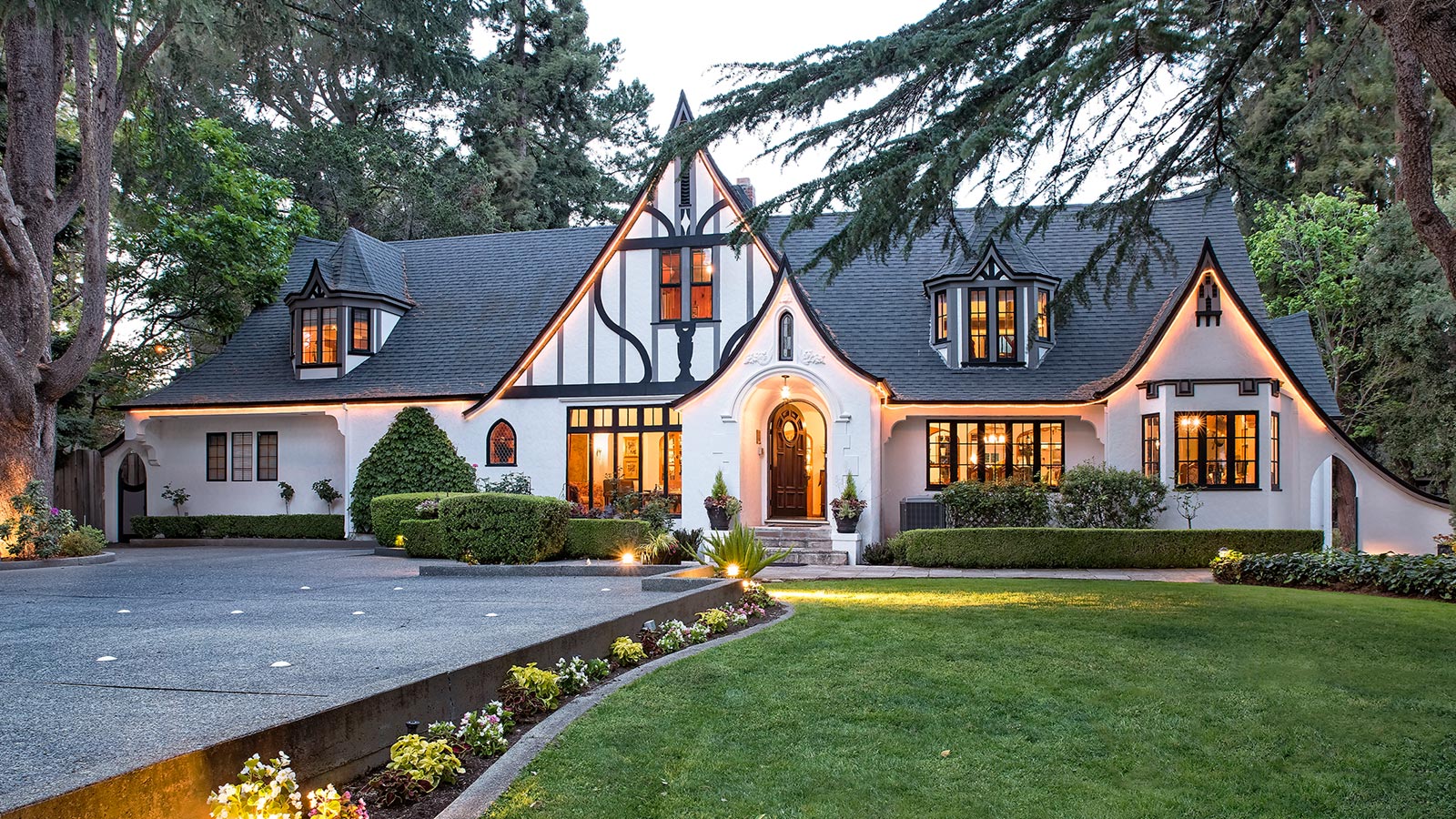 Charming Tudor-style home with manicured front lawn