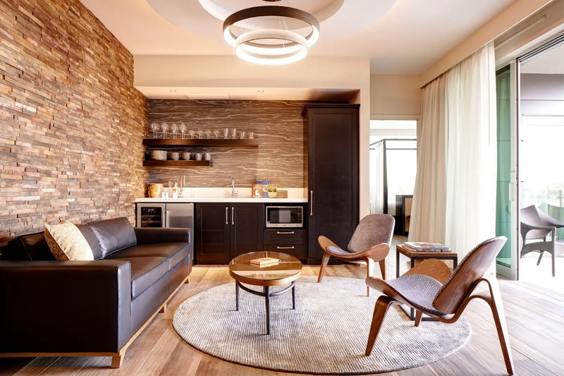 Modern suite with kitchenette, lounge, and balcony view