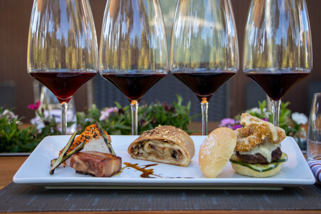 Wine flight paired with gourmet tasting menu outdoors