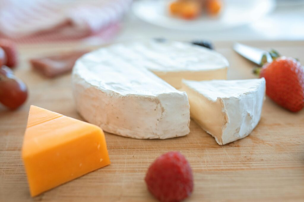 Brie and cheddar cheese with strawberries and grapes