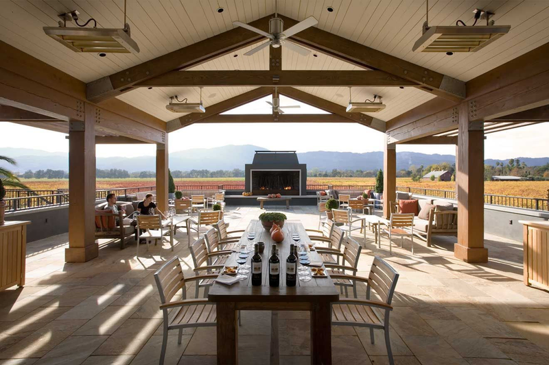 Winery terrace with dining table, fireplace and views