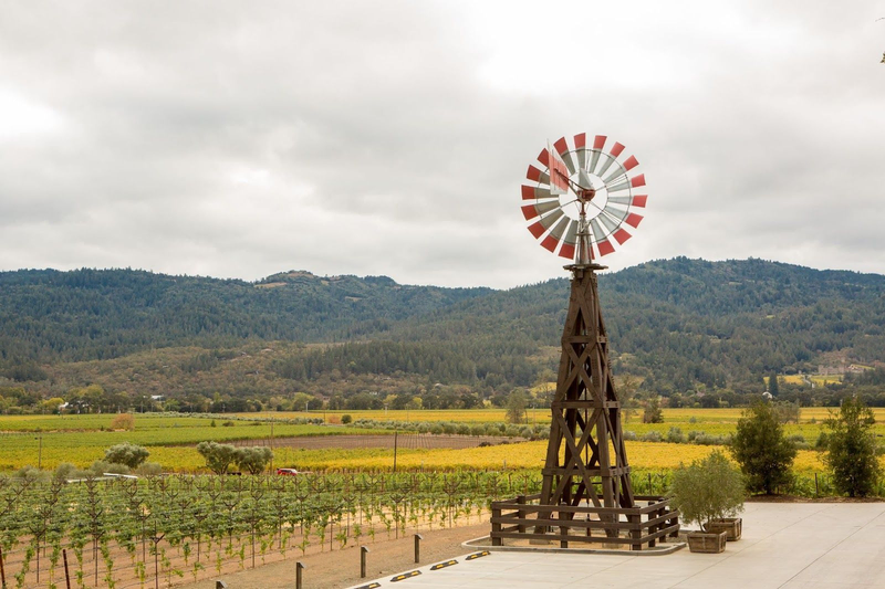 Rustic windmill overlooking vineyards and hills
