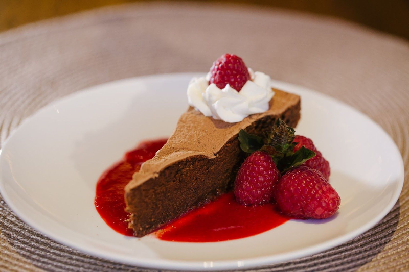 Chocolate cake with raspberries and whipped cream