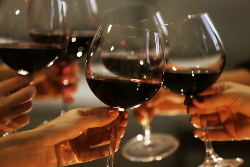 Wine glasses toasting at Davis Estates