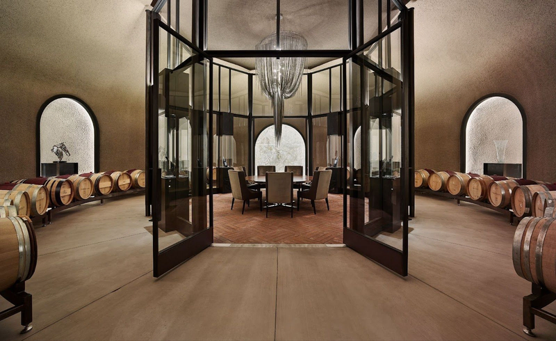 Elegant winery tasting room surrounded by curved rows of barrels