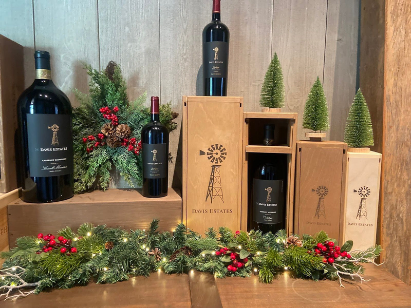 Davis Estates wine gift display with wooden boxes and greenery