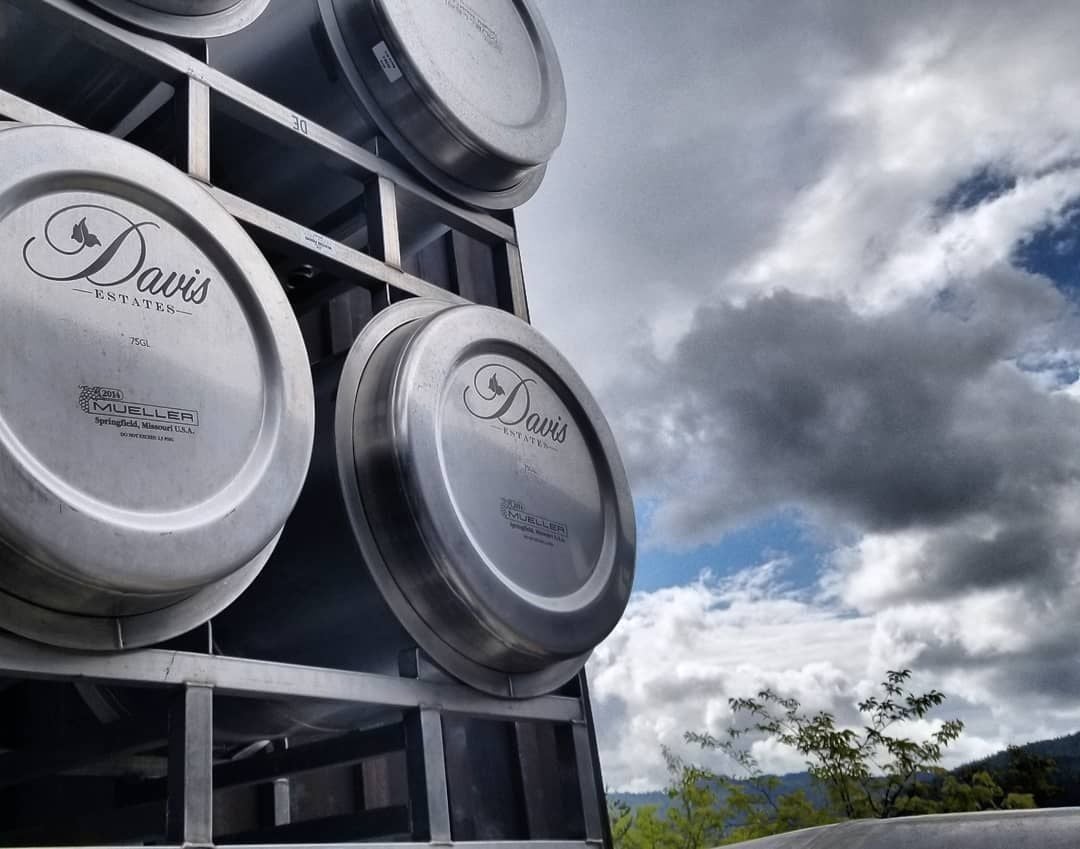 Davis Estates wine tanks under cloudy sky