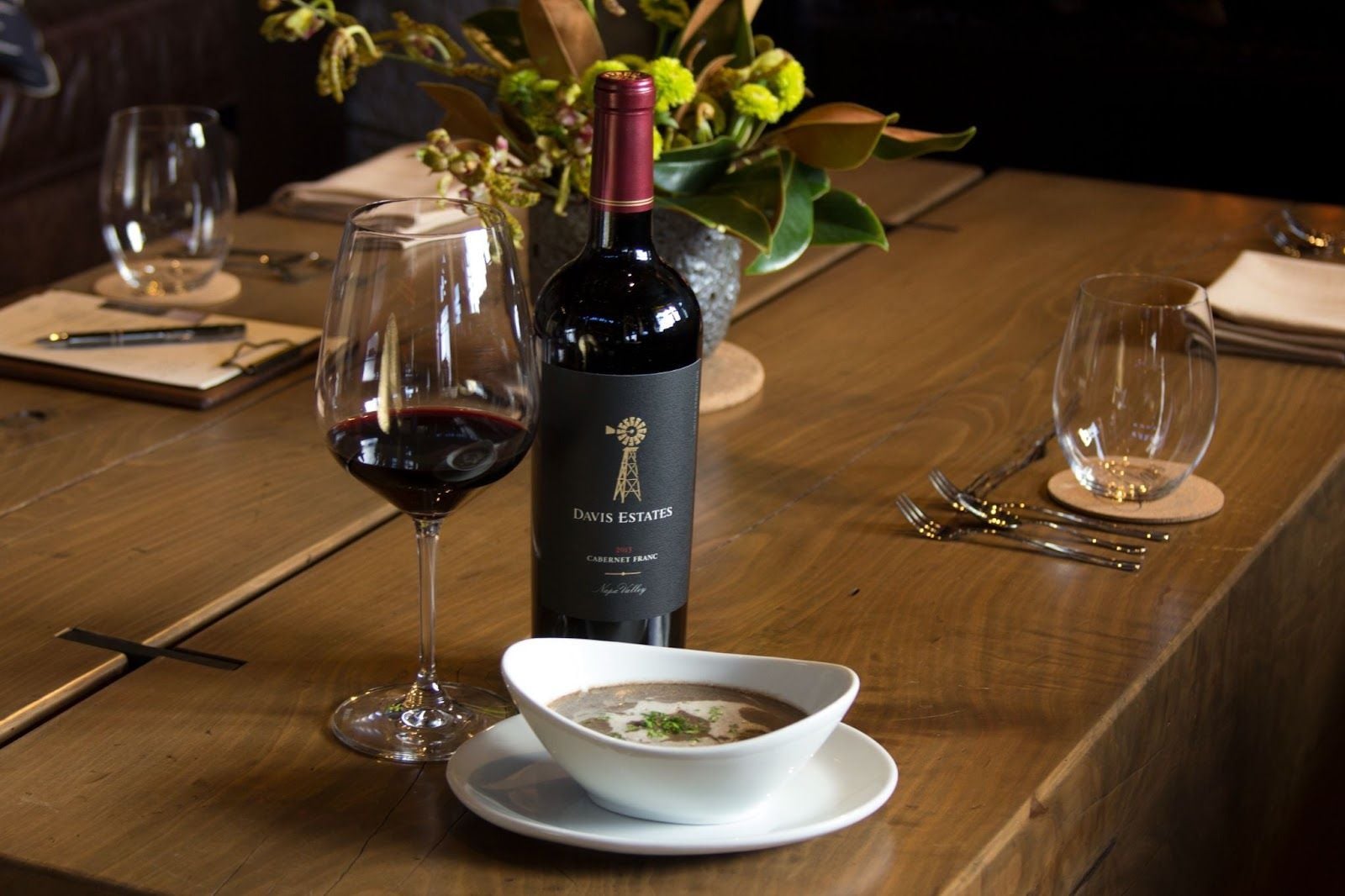 Davis Estates Cabernet Franc with glass on table